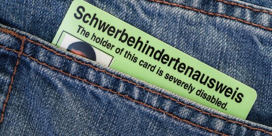 Ein Schwerbehindertenausweis steckt in einer Jeans-Gesäßtasche – Symbolbild für den neuen EU-Behindertenausweis und die Anerkennung von Behinderung in Europa.